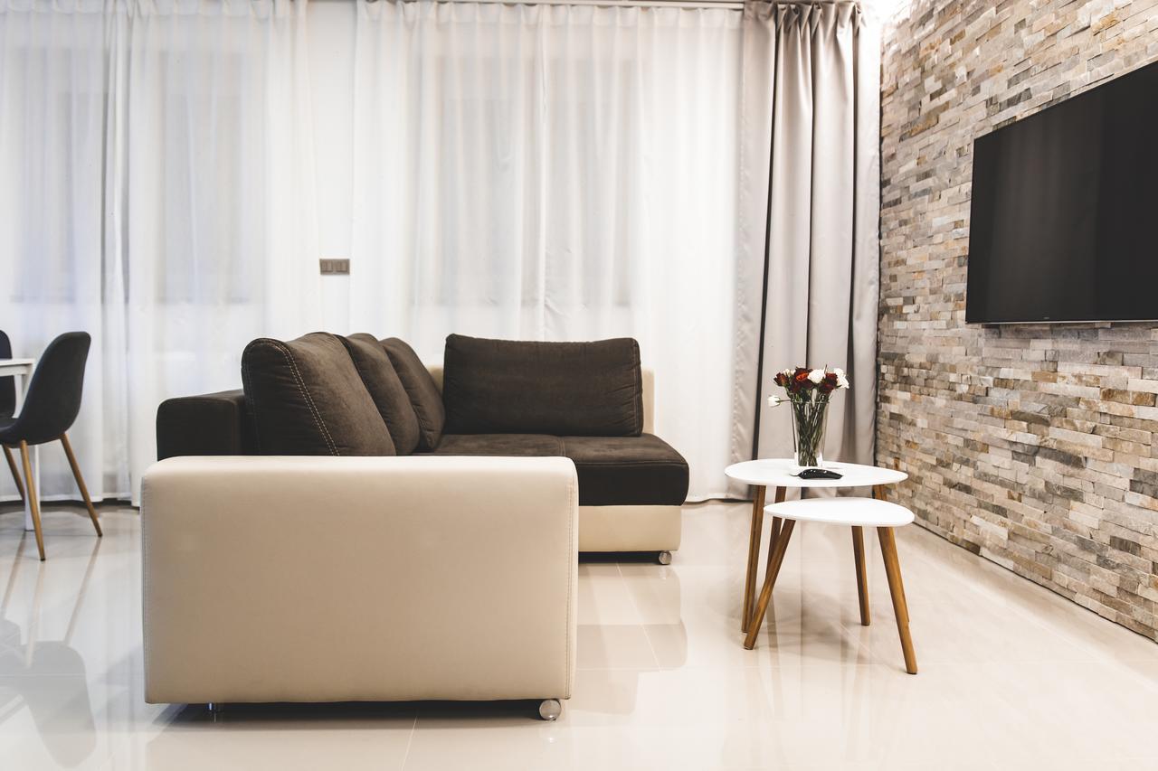 Silesia Residence Ostrava Exteriör bild A living room with a flat screen television